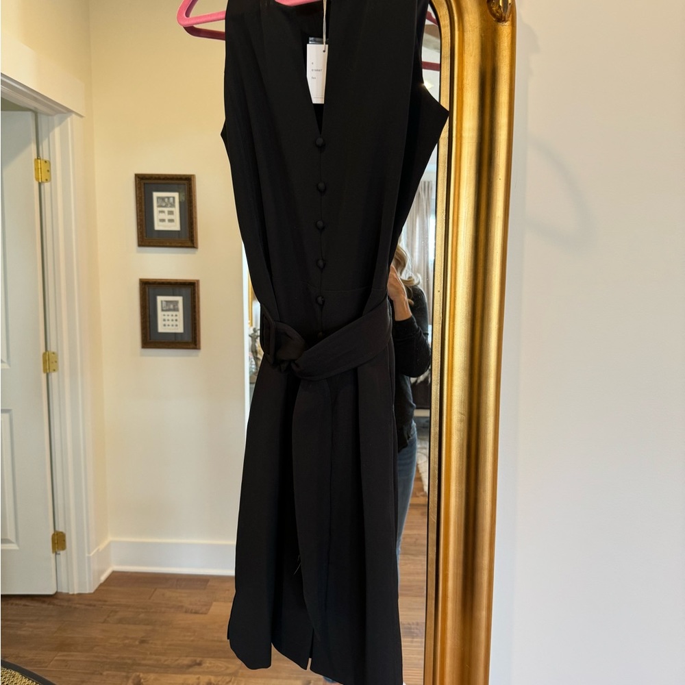 Sleeveless black belted to the knee with pockets never worn black dress